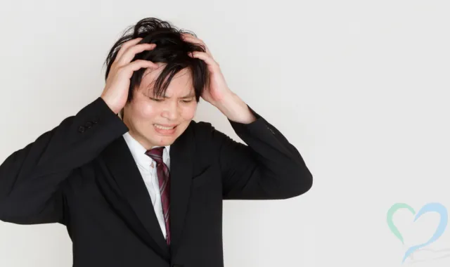 頭を抱える男性