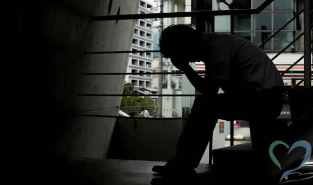 階段でうつむく人